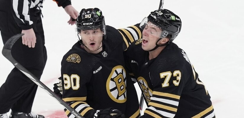 Photo of Bruins players Anthony Richard and Charlie McAvoy celebrating a goal against the Los Angeles Kings.