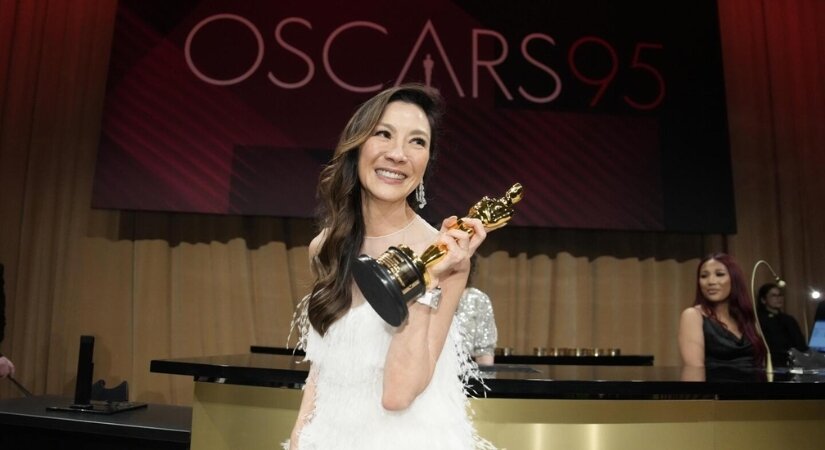 Photos of Michelle Yeoh winning the award for Best Actress at the 2023 Oscars.
