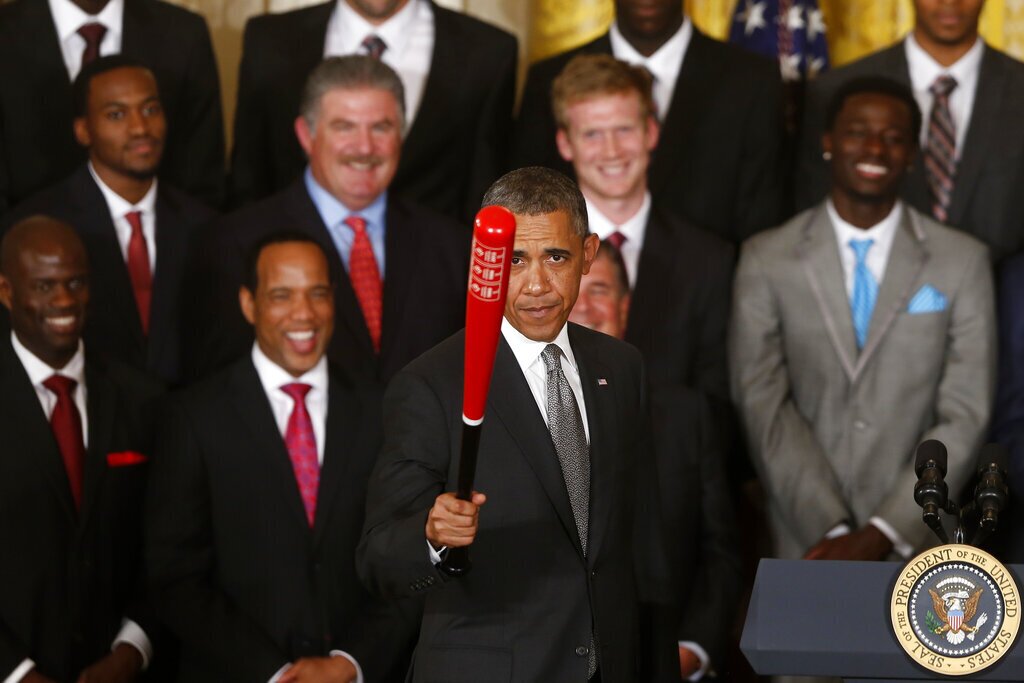 President Barack Obama holds up a Louisville Slugger baseball bat