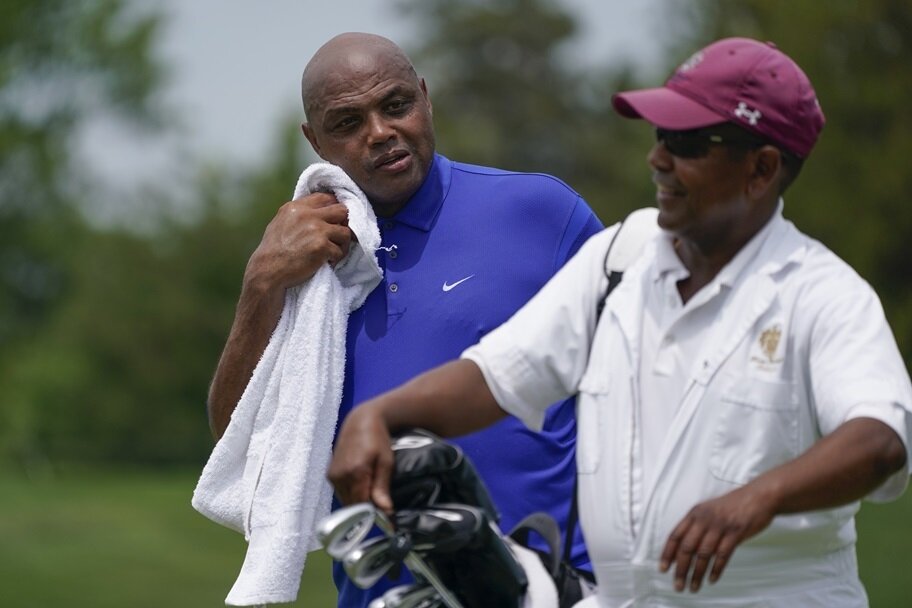 Charles Barkley chats with caddy at LIV Golf tournament.