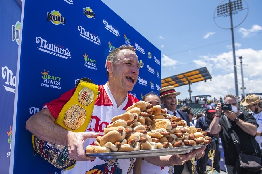 Joey Chestnut poses with tray of hot dogs