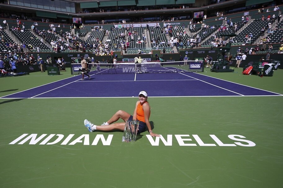 Mirra Andreeva poses with the trophy after winning at Indian Wells.