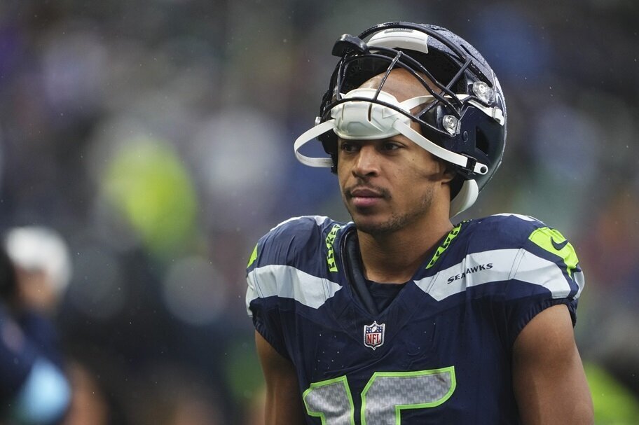 Tyler Lockett walks off the field during an NFL game for Seattle.