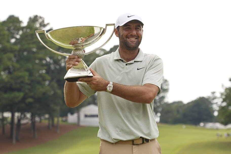 Scottie Schefller poses with the Tour Championship trophy.