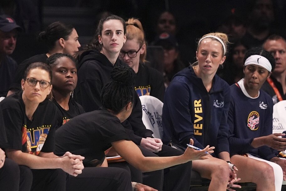 Caitlin Clark watches her Indiana Fever team while inured.