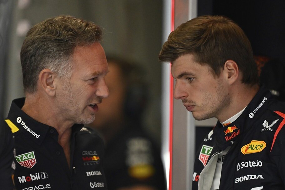 Christian Horner and Max Verstappen talk before a race.