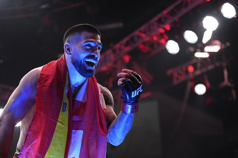 Ilia Topuria celebrates after beating Charles Oliveira for the lightweight belt in the UFC.