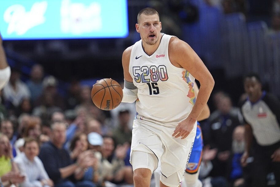 Nikola Jokic looks over the floor in a game for the Denver Nuggets.