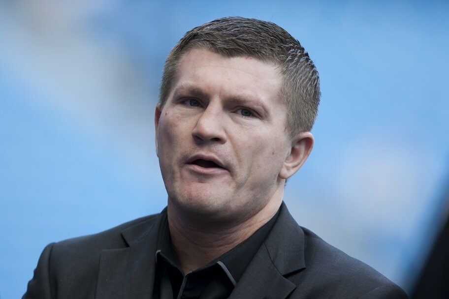 Ricky Hatton stands before a Manchester United-Manchester City soccer game.