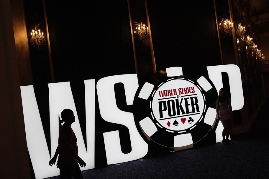 People walk by the WSOP logo