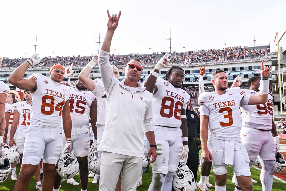 Texas football celebrates a win, led by head coach Steve Sarkisian.
