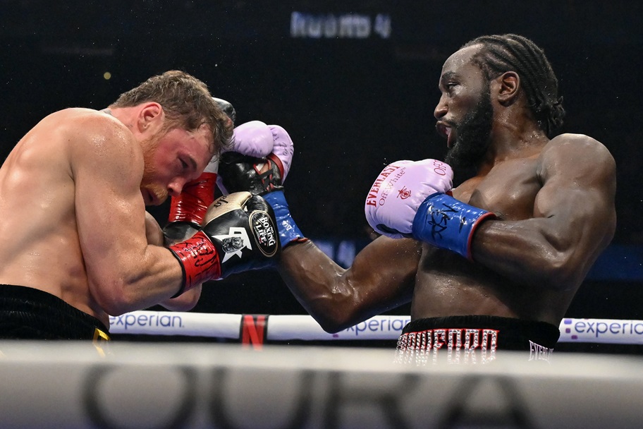 Terence Crawford punches Canelo Alvarez during their fight.