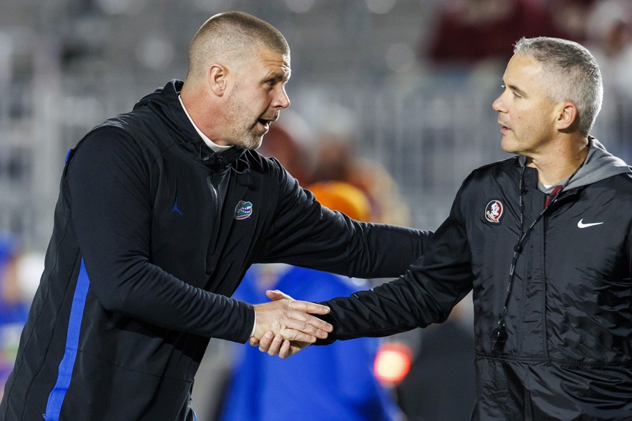 Former Florida coach Billy Napier and FSU coack Mike Norvell shake hands.