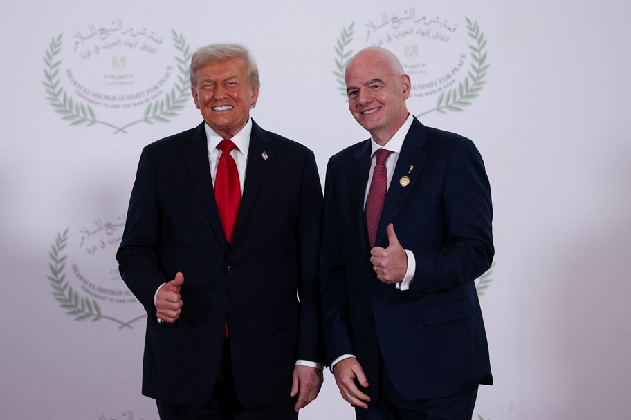 Donald Trump and Gianni Infantino pose for pictures.