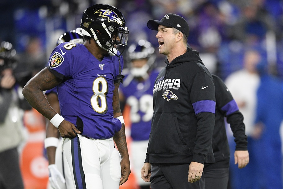 Baltimore's John Harbaugh and Lamar Jackson talk during an NFL game.