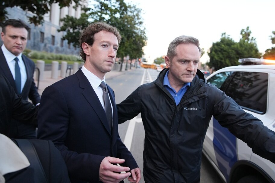 Mark Zuckerberg leaves a courtroom after a trial.